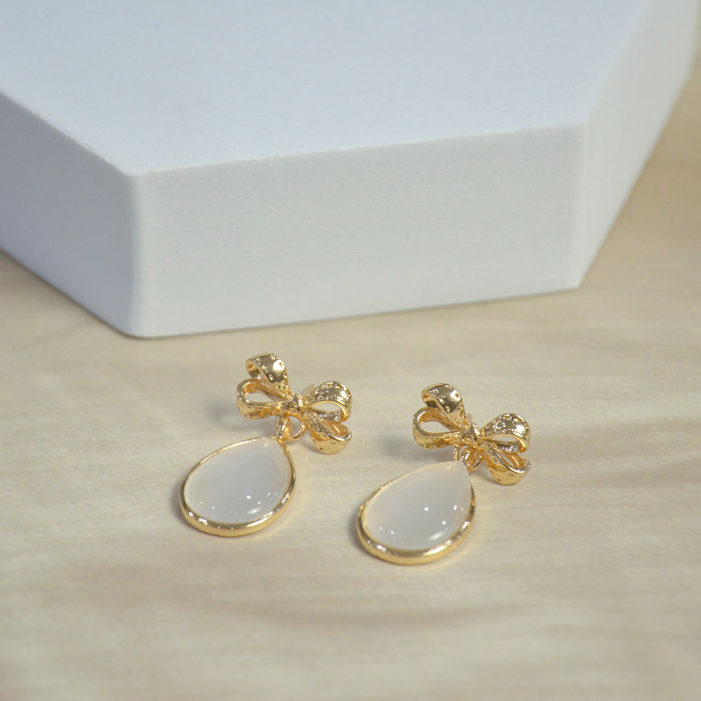 Gold Bow Drop Earrings with White Teardrop Stone