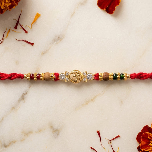 Asymmetric Gemstone Om Gold-Tone Rakhi