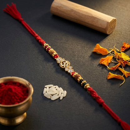 Asymmetric Gemstone Om Gold-Tone Rakhi