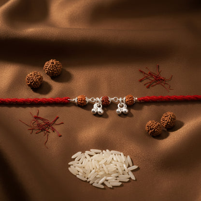 2 PC Rudraksha & Dainty Silver-Finish Bell Rakhi